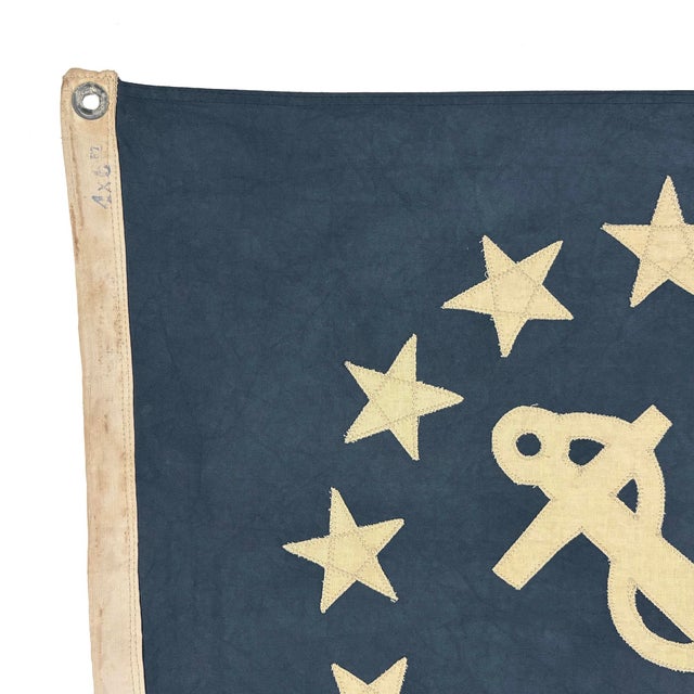 This modified vintage flag is made from a thin cotton cloth and newly embellished with an American yacht ensign emblem....