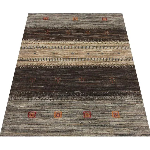 ACTUAL SIZE: 2’10” x 4’5″ PRIMARY COLOR: Brown / Taupe AGE: New MATERIALS: Wool FOUNDATION: Cotton PRODUCTION: Handwoven,...