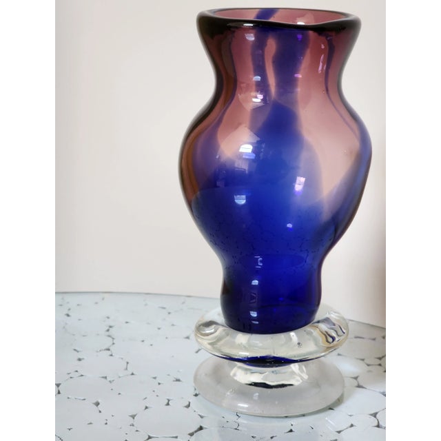 This is an interesting heavy two tone color vase. It is an asymmetrical piece which adds to its charm and beauty.