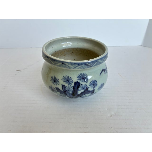 Antique Japanese porcelain censer featuring classic blue and white hand-painted floral and botanical motifs. Rounded form...