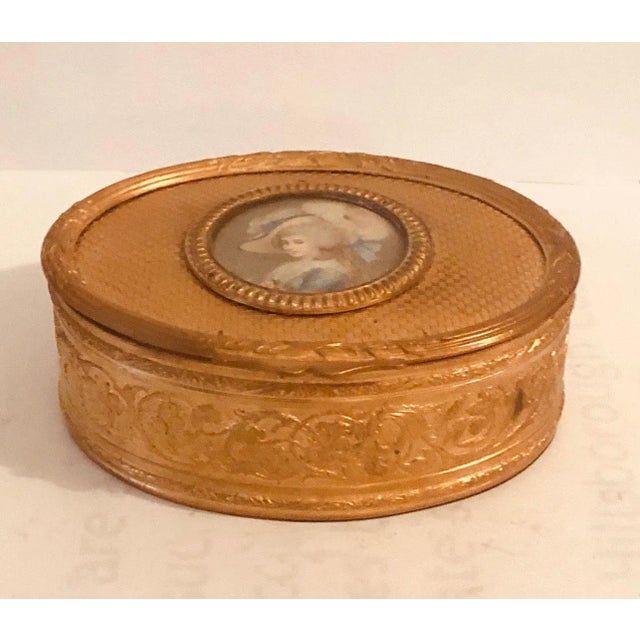 A strikingly beautiful French dore bronze box is all engraved with an ivory picture of an aristocrat, LeBron. The box is...