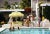 Poolside Party 1970 by Slim Aarons Slim Aarons Limited Estate Edition Guests by the pool at Nelda Linsk’s desert house in...