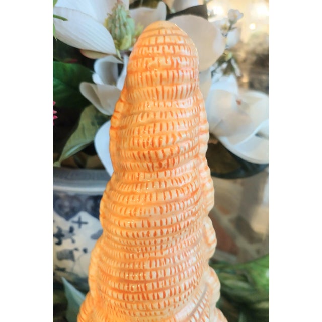 An extra tall ceramic glazed seashell with a wide open back. It can be used as a planter or even as a candle holder. It is...