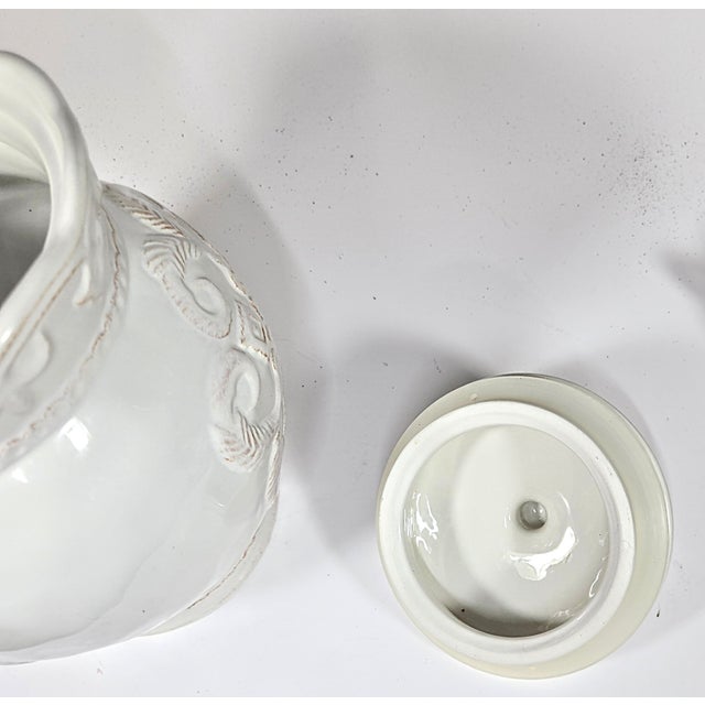 The fleur de lis framing the top section of this gorgeous cookie jar screams France, but the Italian terra cotta clay...