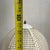Stylish vintage Mid-Century Modern table lamp featuring a white faux bamboo base paired with a woven wicker shade and an...
