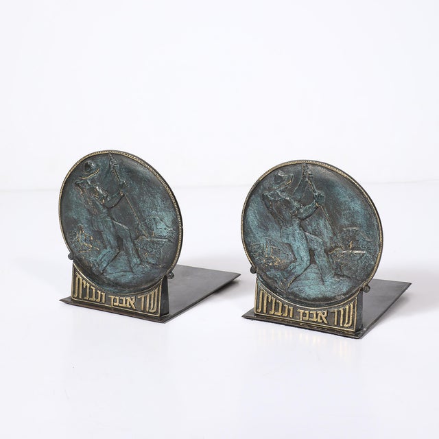 Pair of mid-century modernist bronze bookends depicting stone workers, each rendered in a stylized, muscular relief that...