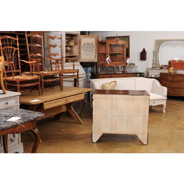 An English Georgian style walnut four-drawer chest from the 20th century with carved legs. This exquisite English Georgian...