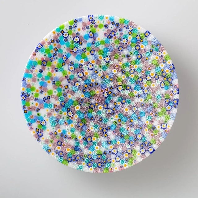 Murano glass plate made by melting together sections of glass rods in a furnace, with each section depicting a small...