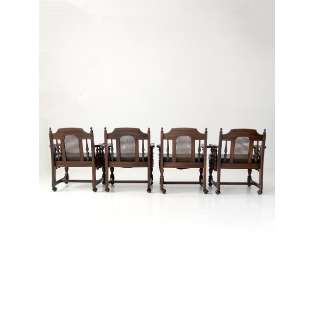 Vintage Colonial Revival game table set featuring a square pedestal table and four matching cane-back armchairs. Turned...