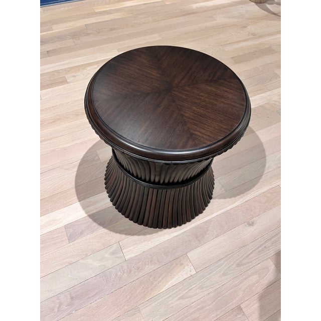 A handy table with a round top veneered with mindi that rests over a colonnade of unpeeled rattan poles. Care...