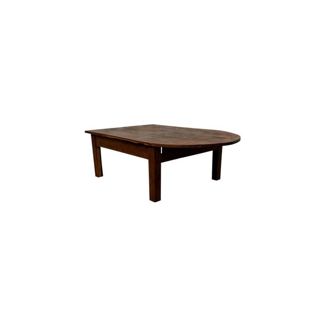 A simple and refined vintage coffee table dating back to the early 1900s, crafted from larch wood and featuring an elegant...