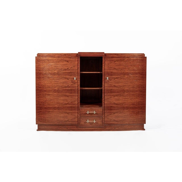 This lovely antique Art Deco mahogany sideboard cabinet or bar cabinet is circa 1940. The cabinet has an elegant profile...