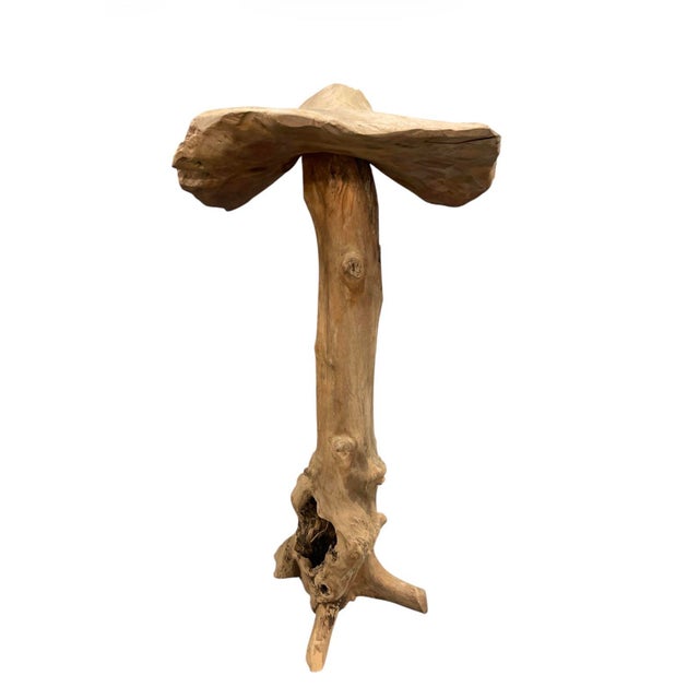 This striking sculptural piece is a masterclass in organic modernism, expertly carved from a single, substantial piece of...