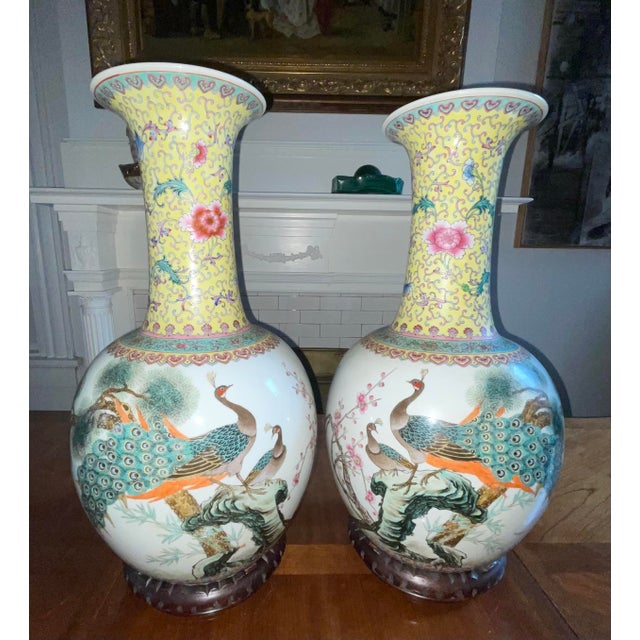 Beautifully scaled pair of large Chinese porcelain vases, hand-painted in the traditional Famille Rose style, featuring...