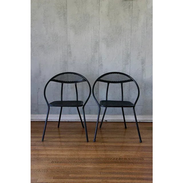 Mid-Century Modern outdoor patio pair of folding chairs designed by Salterini. The chairs are made of mesh and tubular...