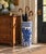 A classic blue and white porcelain umbrella stand in the chinoiserie tradition, featuring finely rendered birds among...