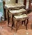 Elegant Rococo style nesting tables featuring a luxurious set of three accent tables topped with sophisticated beige and...
