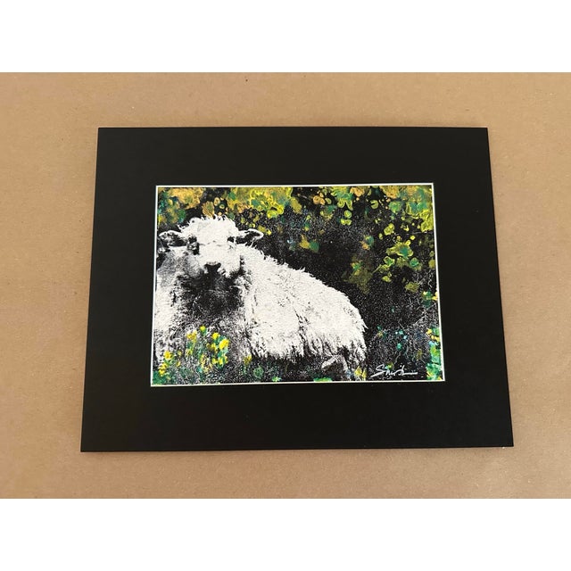 A charming and highly graphic original artwork depicting a sheep in a lush, textured setting. The striking white forms of...