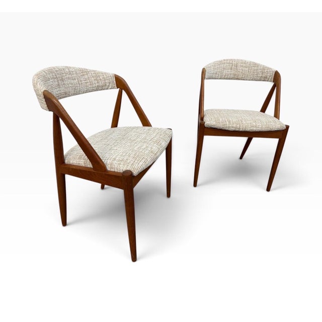 Elevate your dining space with this exceptional pair of Mid-Century Modern Kai Kristiansen Model 31 dining chairs, circa...