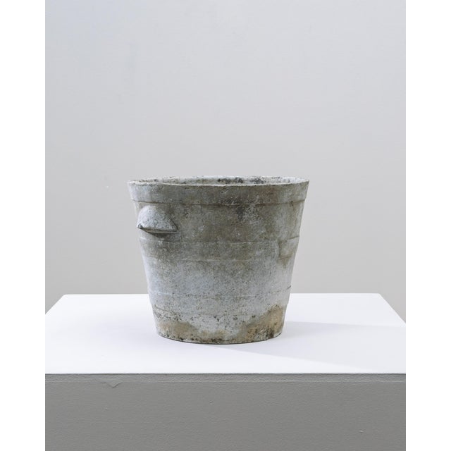 1960s French Concrete Planter. This mid-century French concrete planter features a tapered cylindrical form with subtle...