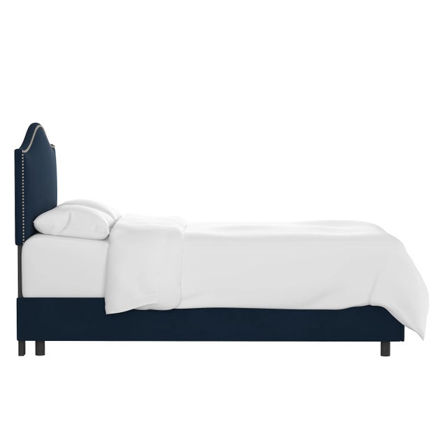 Give your interior a lift with the Bed. Featuring the delicate curves of a classic camelback design, with subtle nailhead...