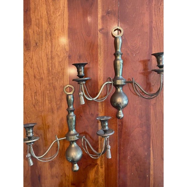 These beautiful two arm wall sconces are made from solid brass and decorated with braid and tassels. Good condition with...