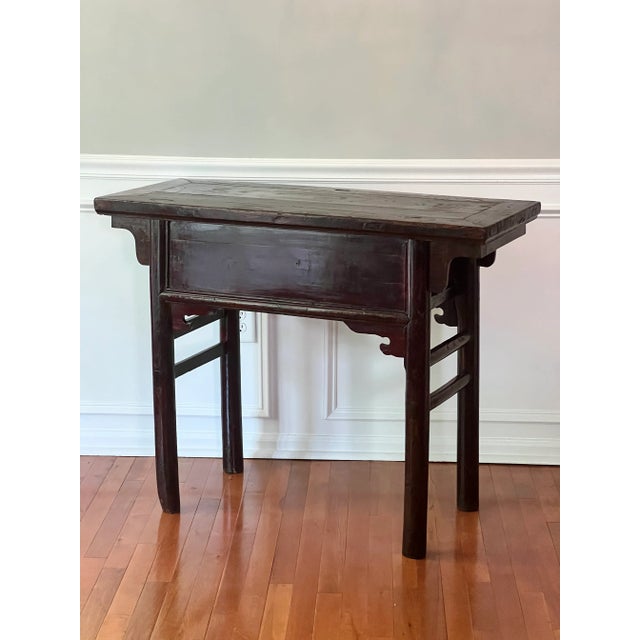 Exquisite antique Chinese elm Alter table, 19th century. Richly hued in tones of wine and deep brown, this lacquered table...