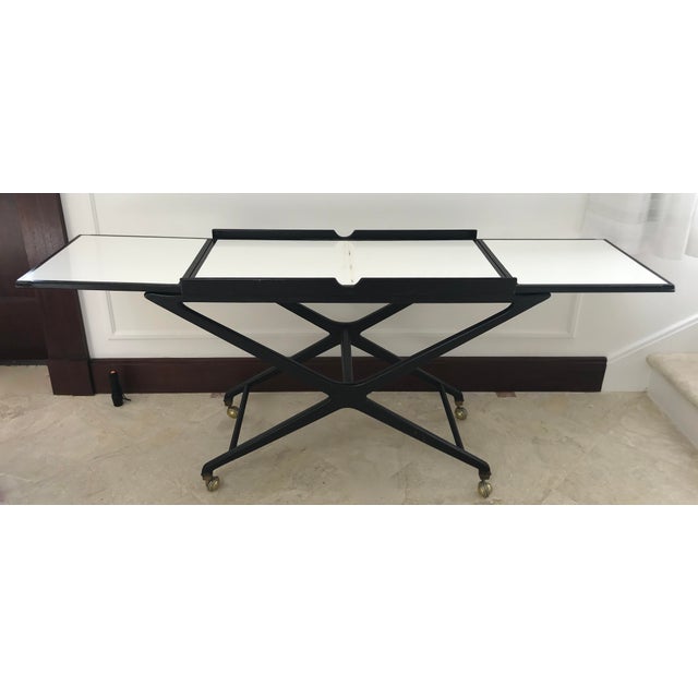 A super stylish mid century bar cart with expandable top. A must have for the woke collector!