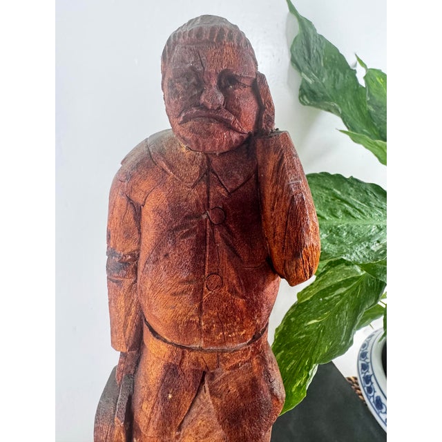 A wonderfully expressive hand-carved wood folk art figure, sculpted from a single block of wood and rich with the...