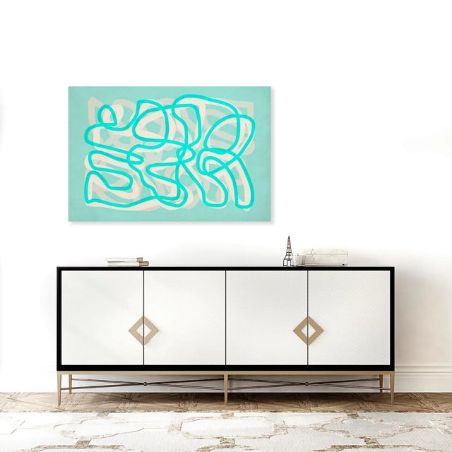 Angela Cameron's squiggle lines artwork plays with colour in a contemporary way. Cream and teal hues mingle and intersect,...