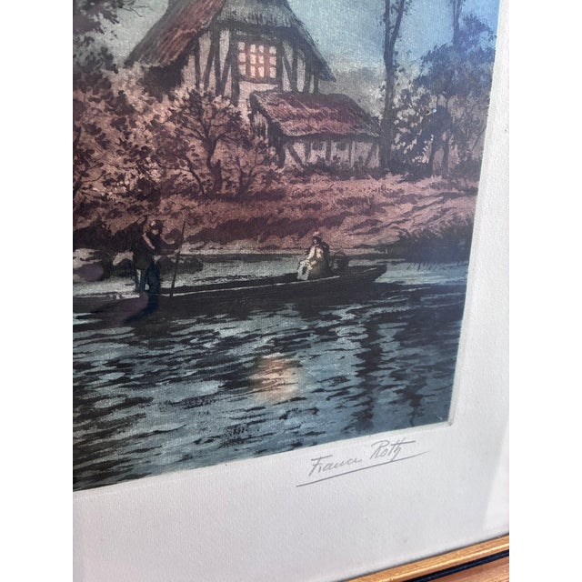 This original vintage landscape print, created around 1970, shows a peaceful river with trees, a boat and a cottage along...