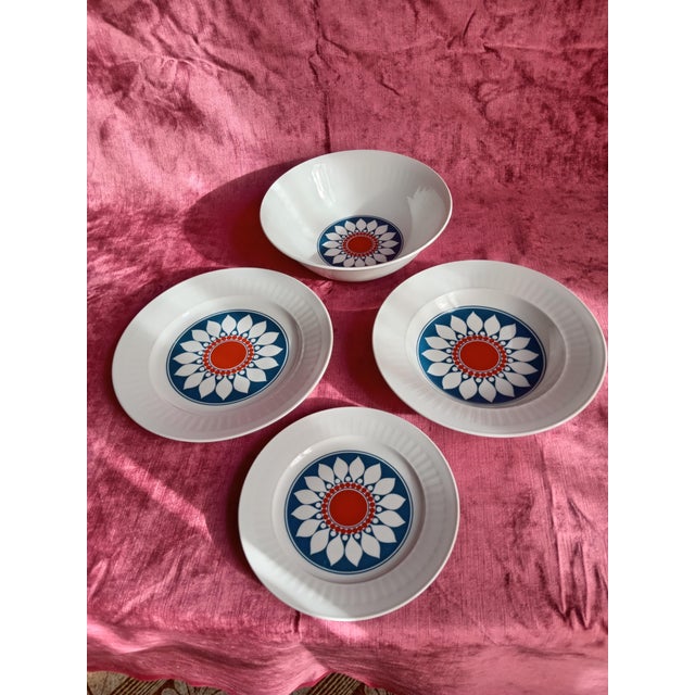 Handcrafted porcelain dinnerware set with a typical 1960s decoration in stunning colors: cobalt and orange on a white...