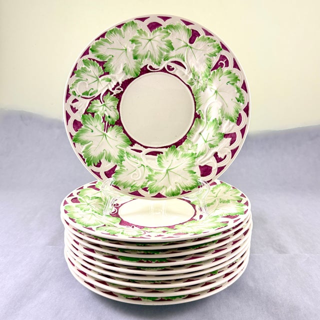 A set of ten Burgundy and Green Leaf bordered plates, Wedgwood, England, circa 1910-1920. An earthenware mold with a...