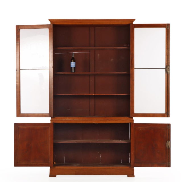 This two-piece Italian cabinet dates to the 19th century and is crafted in warm, richly figured cherry. The upper section...