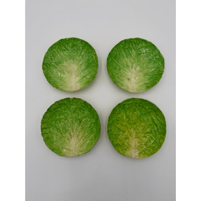 A set of four late nineteenth-century Italian majolica plates by EB Napoli, modeled in trompe l'oeil relief as curled...