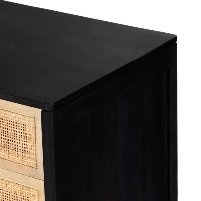 Solid, black-finished mango encases inset woven natural cane, for a textural take on bedside storage. Assembly Required? No