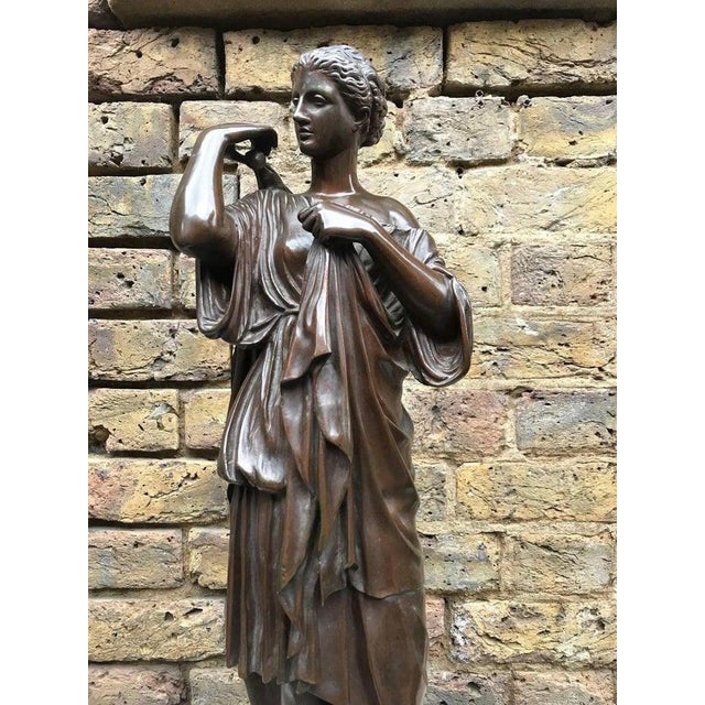19th century statue of a bronze Roman goddess. Signed gift from Musee du Louvre. H 23 in. x Dm 9.8 in. H 58.42 cm x Dm...