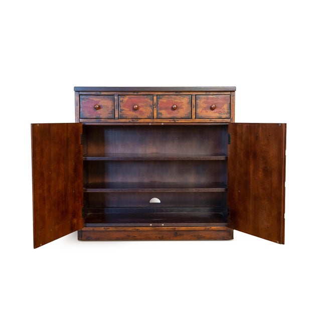 Apothecary-style cabinet combining classic form with a more contemporary double-door design. The front features a faux...