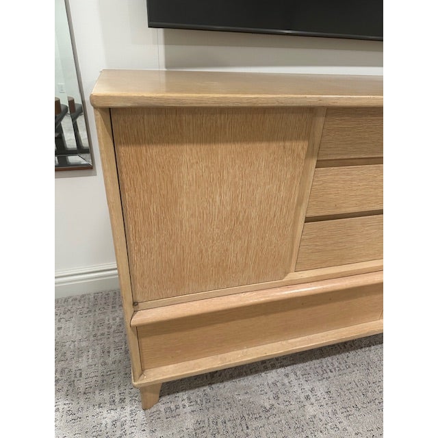 This is a beautiful sideboard from the 50s. Right on trend, this piece has clean lines with the original cerused finish....