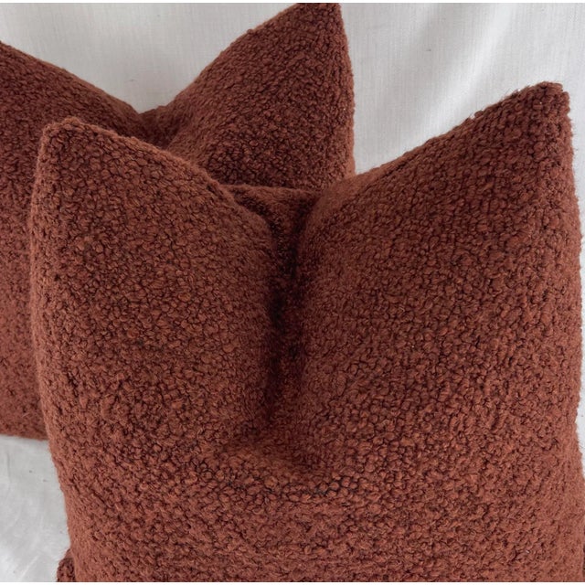 Custom pair of 22" pillows covered in Chelsea Textiles "Kingswood Boucle" in color brick. These pillows have tapered...