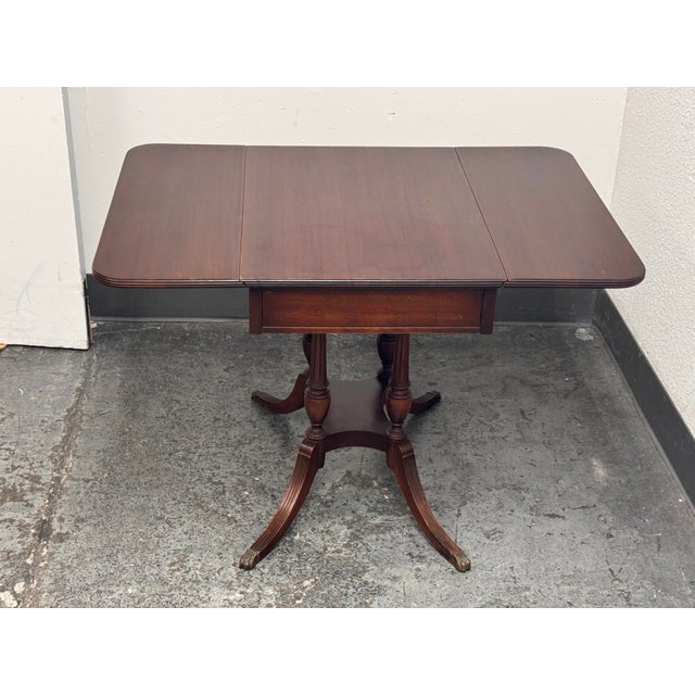Design Plus Gallery presents a Vintage Imperial Furniture Co. Mahogany Drop-Leaf Pembroke Table. This vintage table...