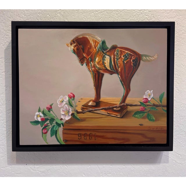 This artwork features a beautifully rendered wooden horse, adorned with intricate details, standing atop a rustic crate....