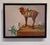 This artwork features a beautifully rendered wooden horse, adorned with intricate details, standing atop a rustic crate....