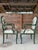 A striking and sculptural pair of faux bois carved wood armchairs, evocative of mid-20th century French design in the...