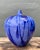 This striking vintage ceramic vase features a captivating drip glaze in deep cobalt blue over a serene periwinkle base....