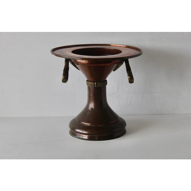 A vintage Ottoman Turkish-style copper brass brazier, known as a mangal, featuring decorative brass handles and a pedestal...