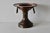 A vintage Ottoman Turkish-style copper brass brazier, known as a mangal, featuring decorative brass handles and a pedestal...