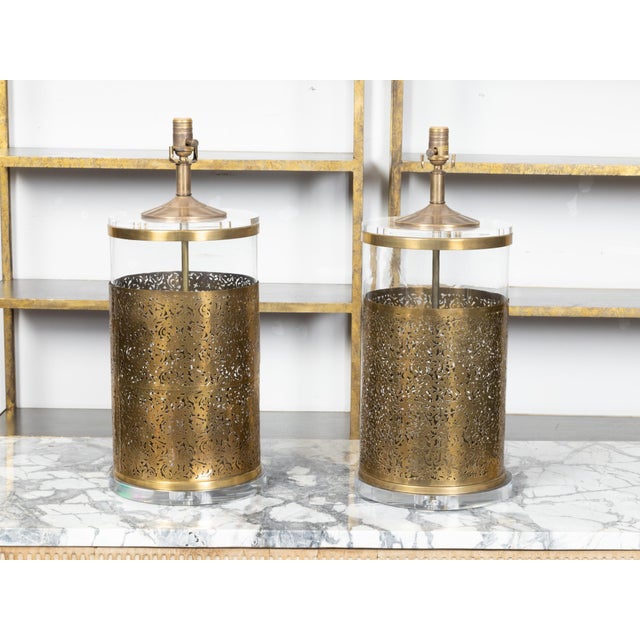 A pair of English vintage brass and glass table lamps from the late 20th century, with openwork motifs, custom made lucite...