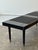 Simplicity at its finest. This vintage 1960s black slatted bench brings the perfect touch of mid-century modern minimalism...