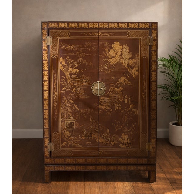 A stunning vintage Drexel chinoiserie bar cabinet featuring intricate hand-painted inlay, rich walnut tones, and a...